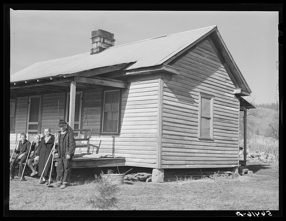 [Untitled photo, possibly related to: Dutton ("Dut") Calleb and his family with their homemade hoes on the porch of their…