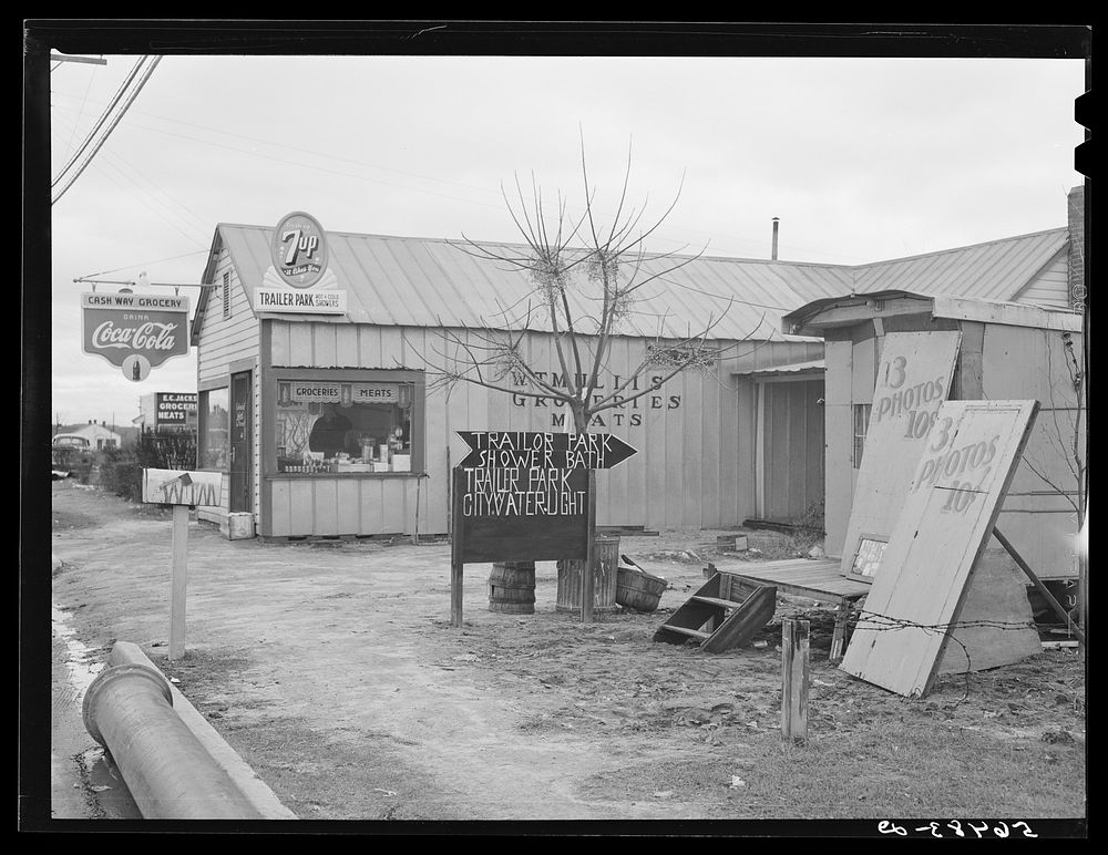[Untitled photo, possibly related to: New sign in front of trailer park, and Itinerant photographer's trailer on highway…