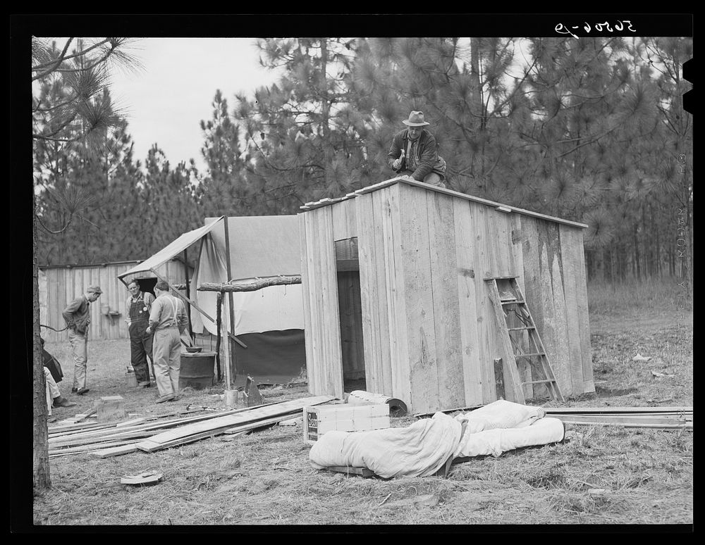 J.R. Jones from Monroe, Louisiana, building new shack to live in temporarily while works on construction job at Camp…
