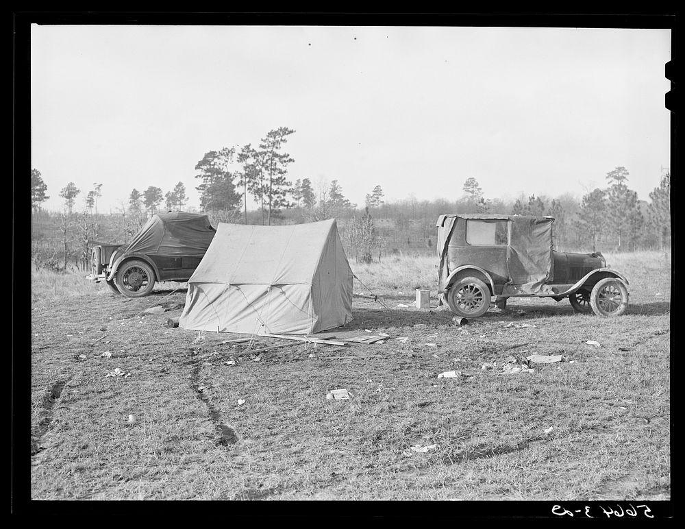 Tent, car, and farm truck. Used for sleeping and general housing by construction workers off highway near Camp Claiborne.…