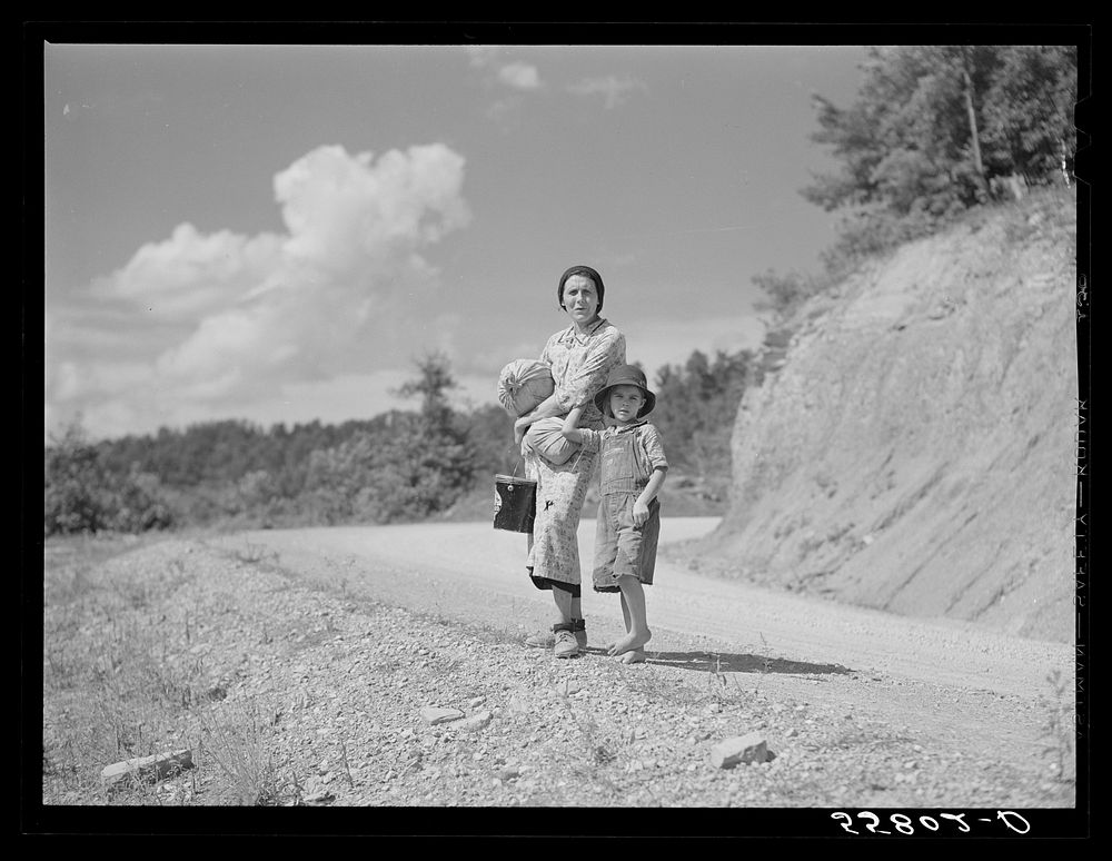 Mountain woman carrying home groceries from the store. Near Hyden, Kentucky. Sourced from the Library of Congress.