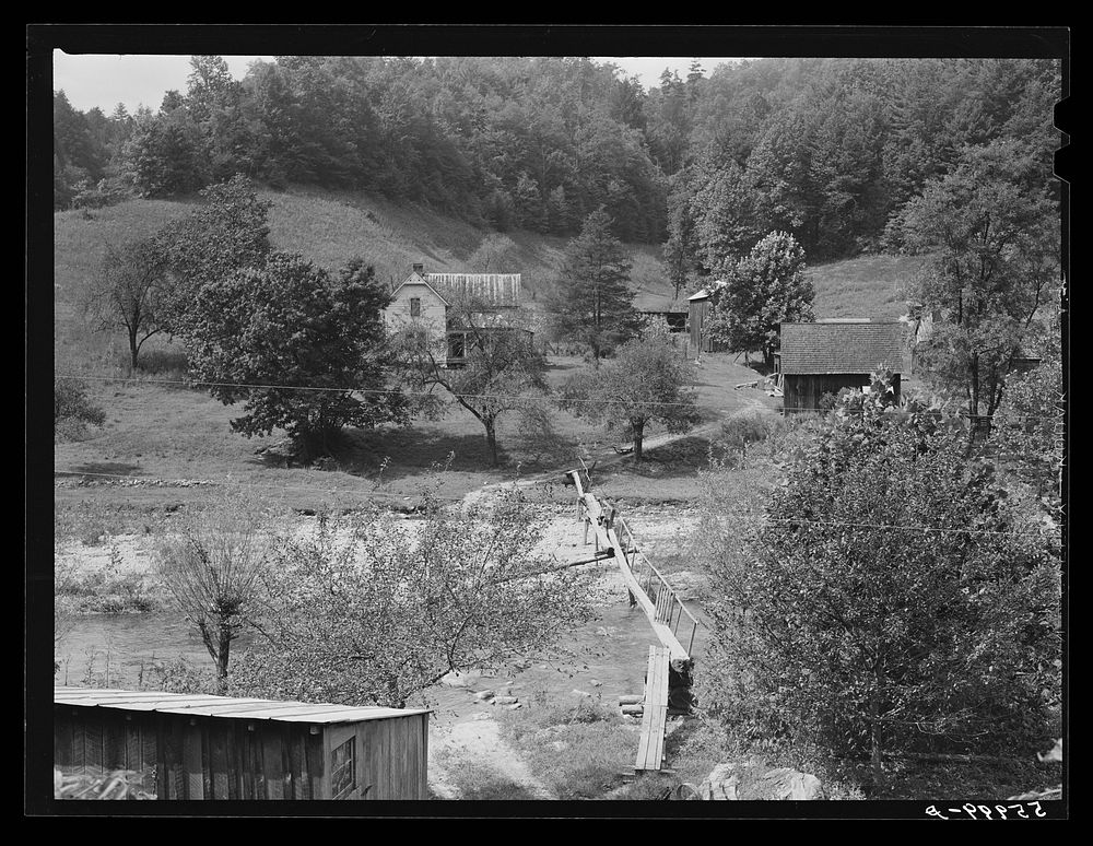 Farmhouses along creek bed on recently flooded area northwest of Asheville, North Carolina. Sourced from the Library of…