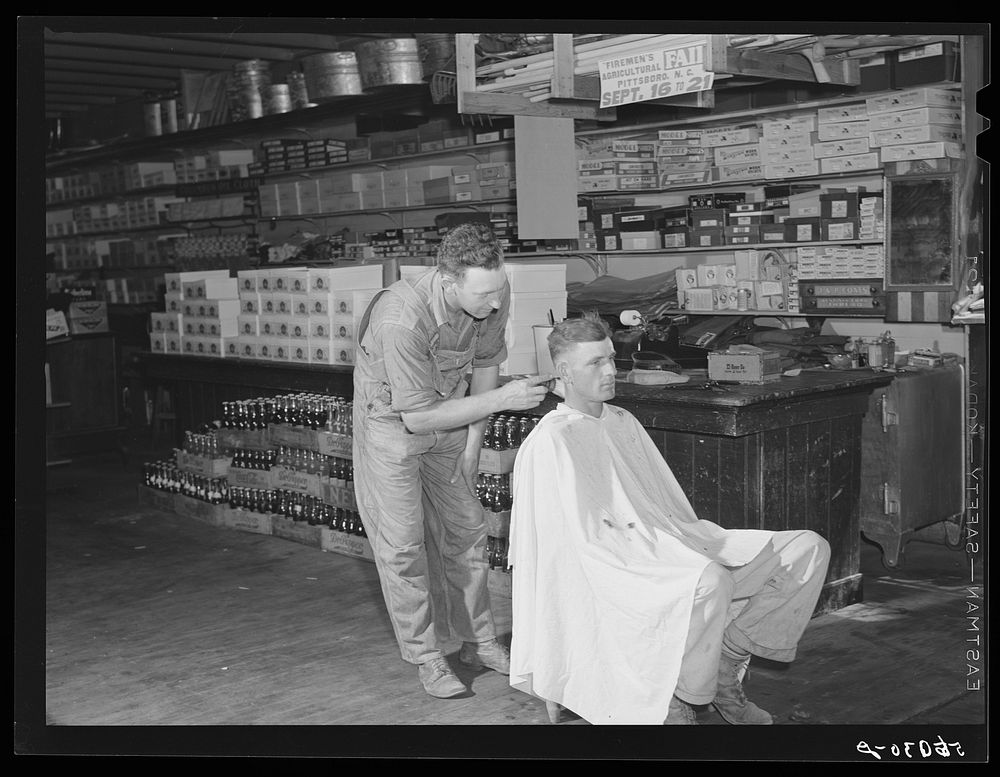 Free haircut on Saturday morning in W.M. Scott's general store. Farrington, Chatham County, North Carolina. Sourced from the…