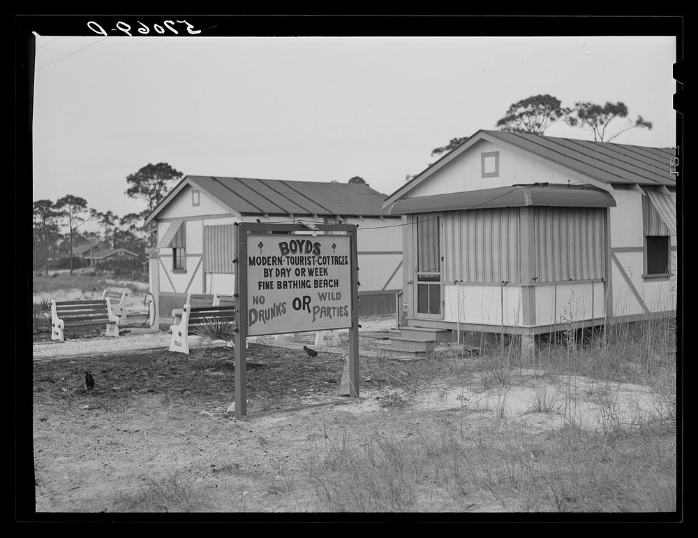 [Untitled photo, possibly related to: Sign advertising tourist cottages on highway outside Pensacola, Florida]. Sourced from…