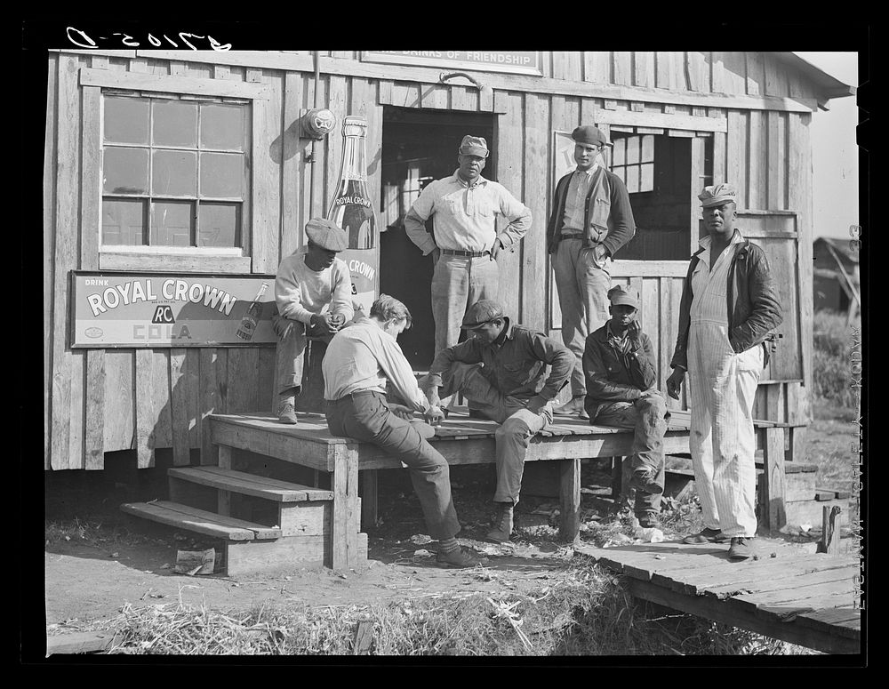 Migratory laborers playing checkers in front of juke joint during slack season for vegetable pickers. Belle Glade, Florida.…