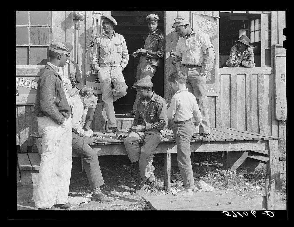 Migratory laborers playing checkers in front of juke joint during slack season for vegetable pickers. Belle Glade, Florida.…