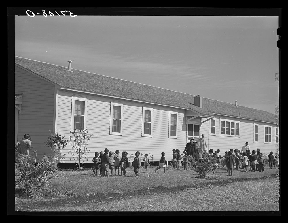  children playing outside of nursery at Okeechobee migratory labor camps built by FSA (Farm Security Administration). Belle…