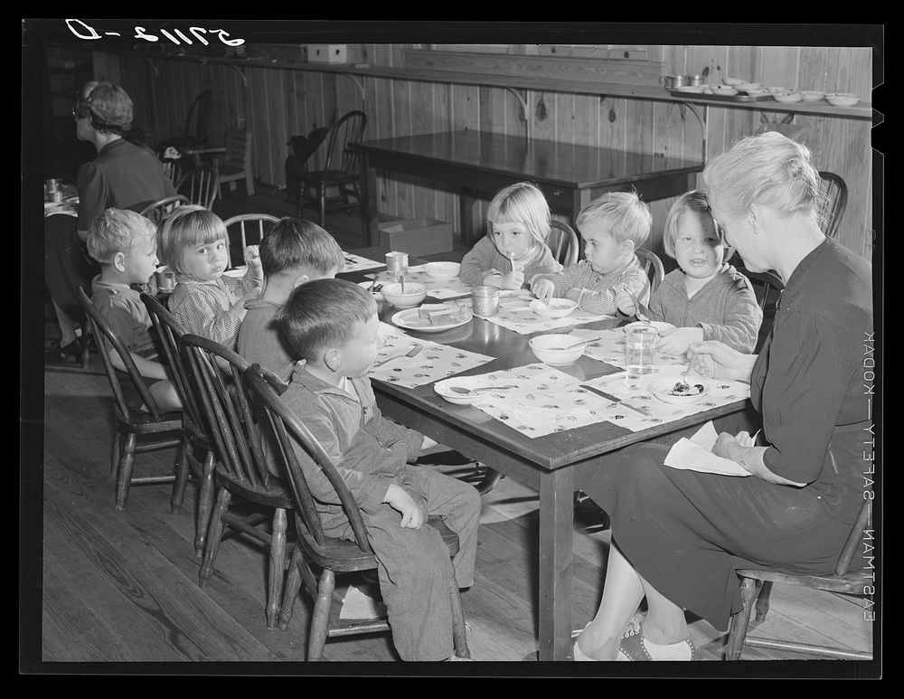 Children of migratory workers eating lunch in twenty-four hour nursery at Osceola migratory labor camp built by FSA (Farm…