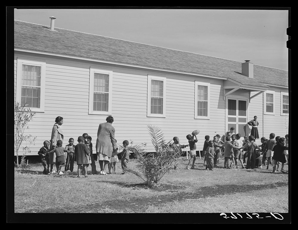 Children of migratory laborers outside of day nursery at Okeechobee migratory labor camp. Belle Glade, Florida. Sourced from…