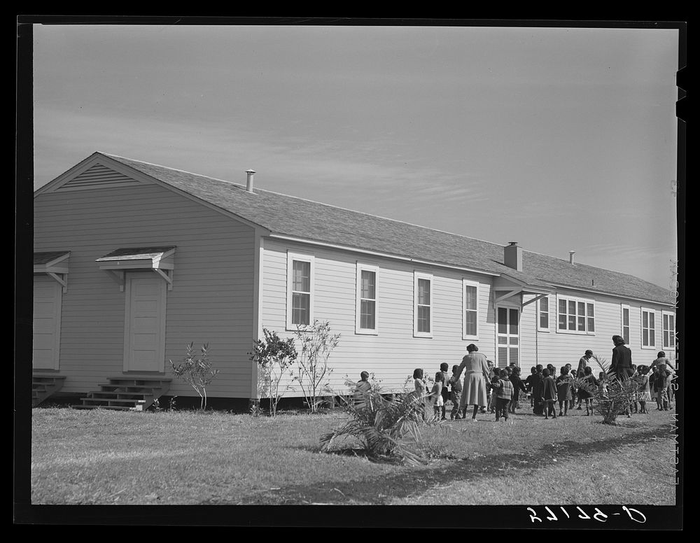 Children of migratory laborers outside of day nursery at Okeechobee migratory labor camp. Belle Glade, Florida. Sourced from…