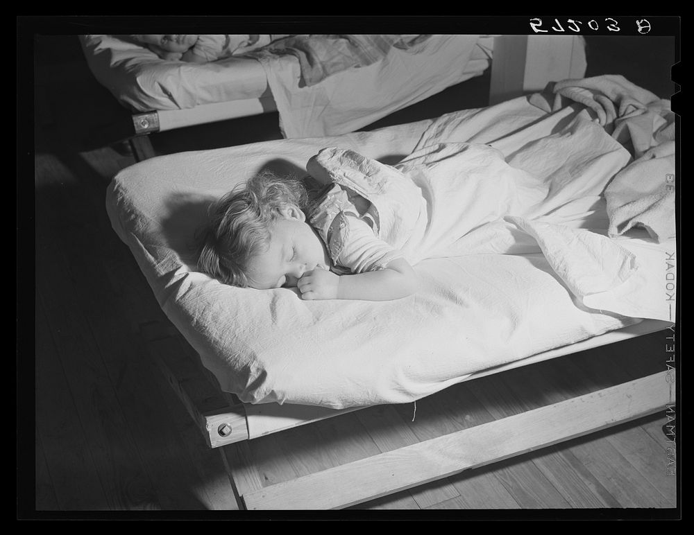 Child of agricultural and packing house worker taking rest hour in twenty-four hour a day nursery at Osceola migratory labor…