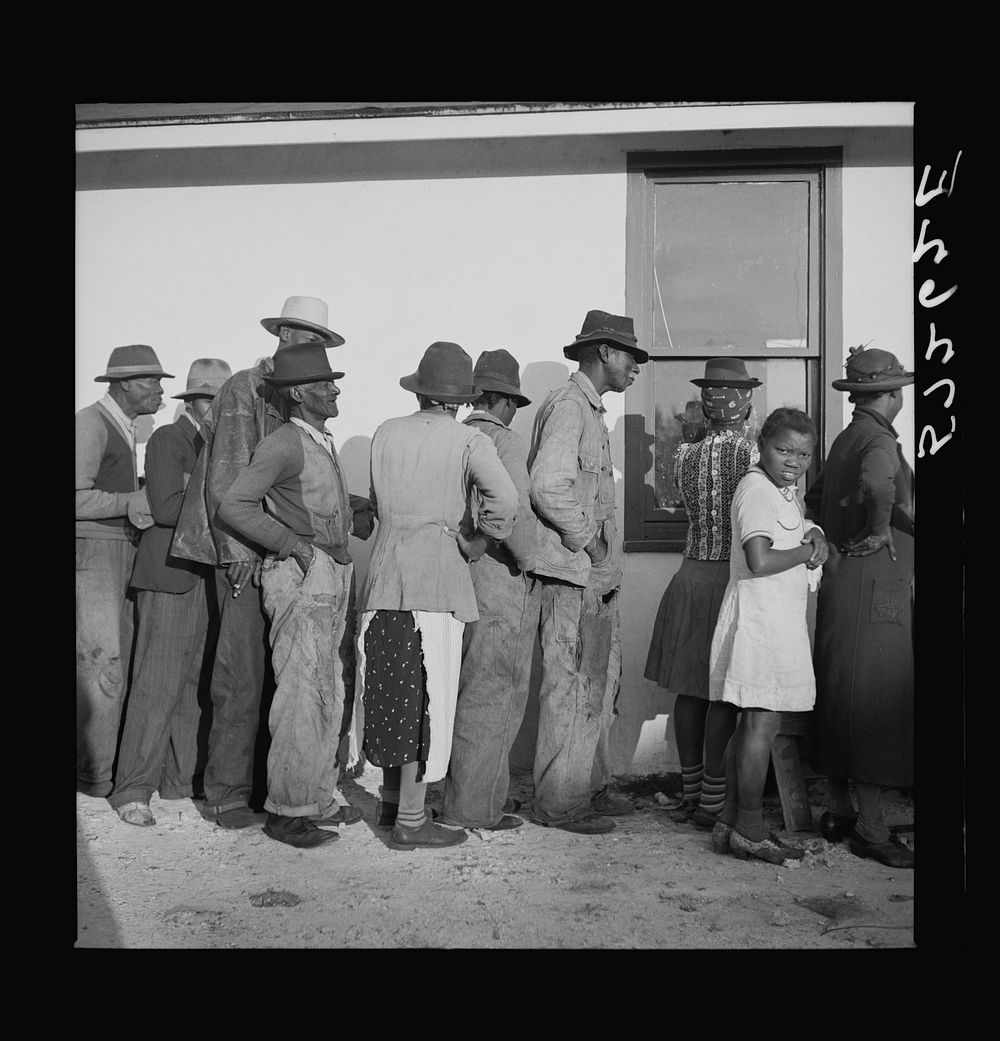 Migratory workers waiting to receive supplies of surplus commodities. Belle Glade, Florida. Sourced from the Library of…