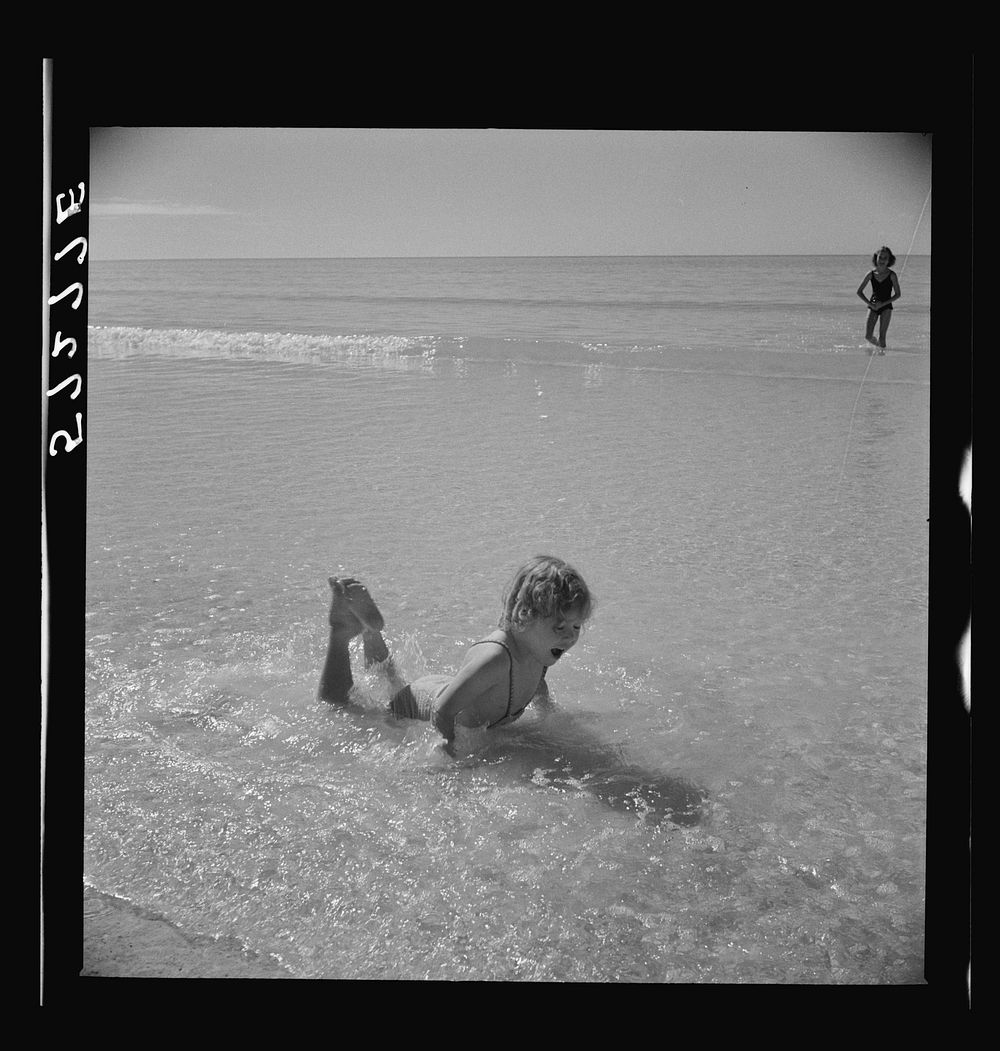 [Untitled photo, possibly related to: Daughters of guests at Sarasota trailer park, Sarasota, Florida, playing in water…