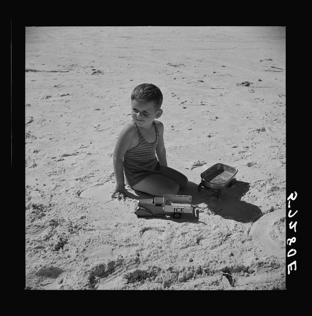 Son of parents who live at Sarasota trailer park, Sarasota, Florida, playing on the beach. Sourced from the Library of…