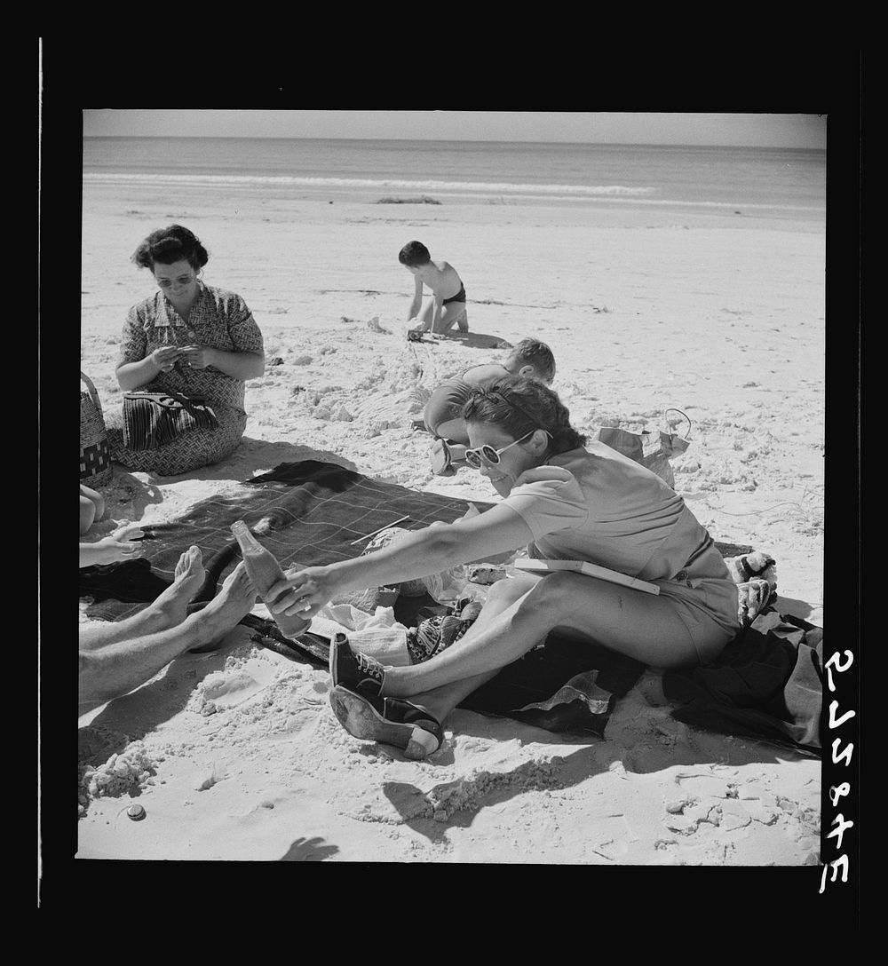 [Untitled photo, possibly related to: Guest of Sarasota trailer park, Sarasota, Florida, at the beach with her family].…