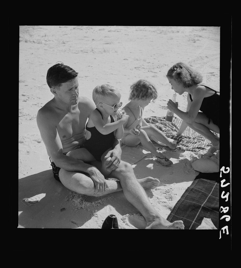 Guest of Sarasota trailer park, Sarasota, Florida, with his family, picnicking at the beach. Sourced from the Library of…
