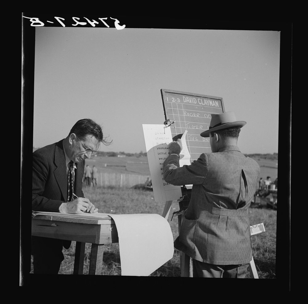 Bookie figuring out bets for Kentucky derby. Warrenton, Virginia.. Sourced from the Library of Congress.