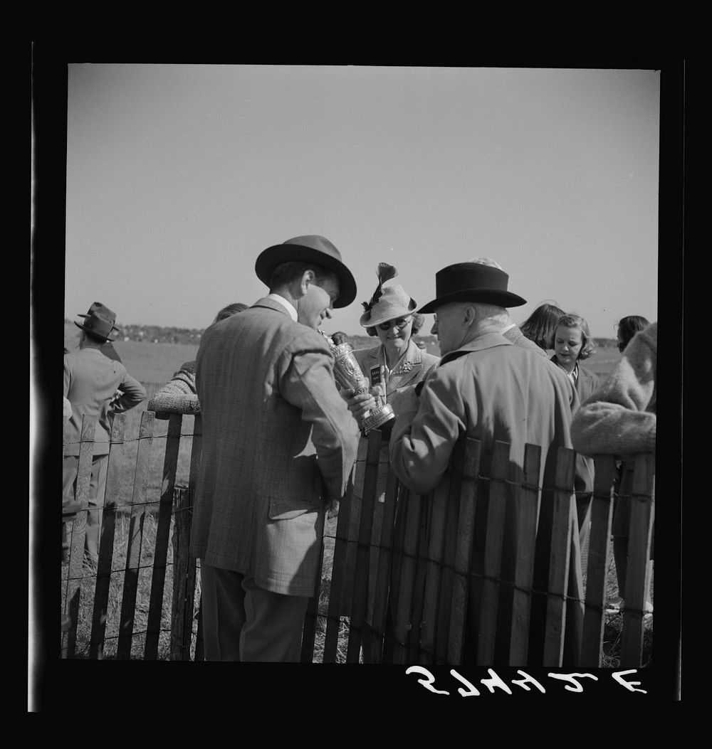 Looking at the gold cup. Horse races at Warrenton, Virginia. Sourced from the Library of Congress.