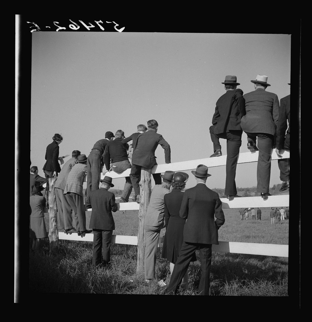 Spectators at paddock fence between races. Warrenton, Virginia. Sourced from the Library of Congress.