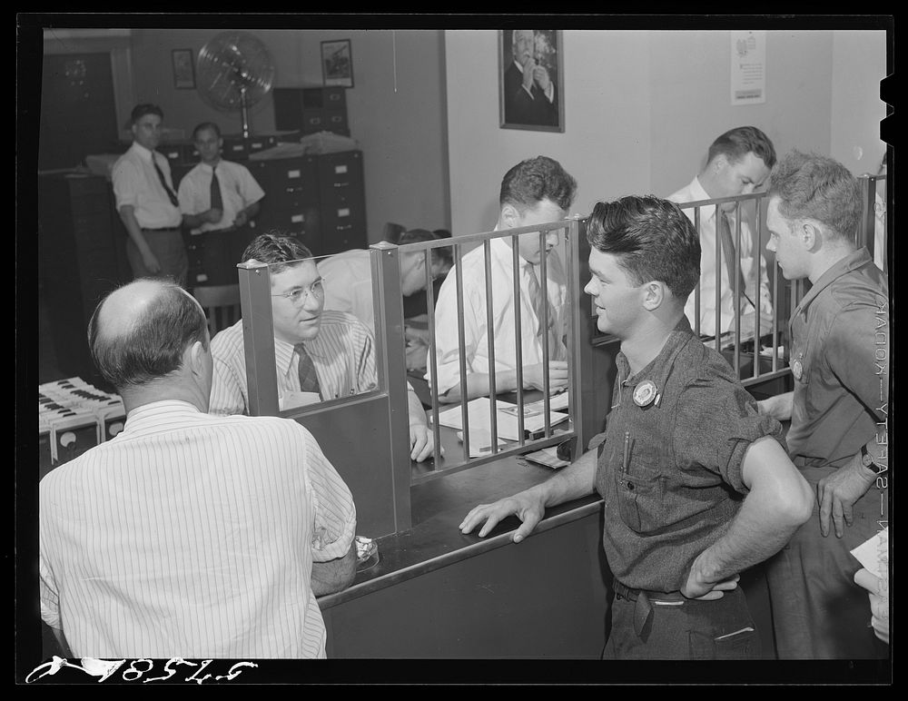 Pratt and Whitney worker at the United Aircraft credit union. East Hartford, Connecticut. Sourced from the Library of…