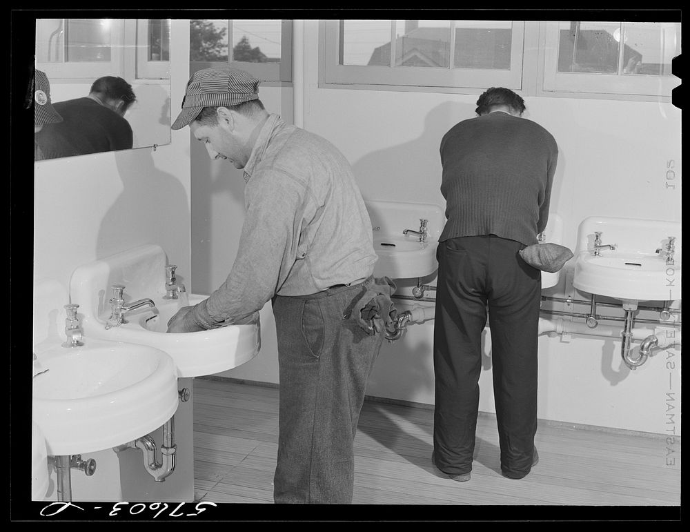 [Untitled photo, possibly related to: Workers from electric boat company plant in washroom of new dormitories for defense…
