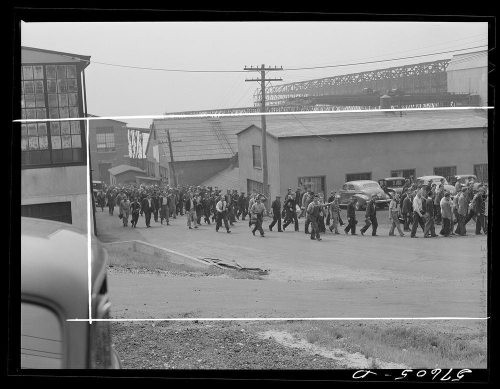 Workers coming out of the electric boat works at the afternoon change of shift. Groton, Connecticut. Sourced from the…