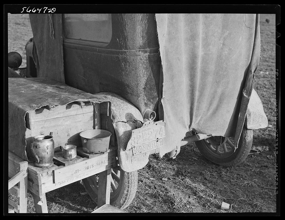 [Untitled photo, possibly related to: Tent, car, and farm truck, used for sleeping and general housing by construction…