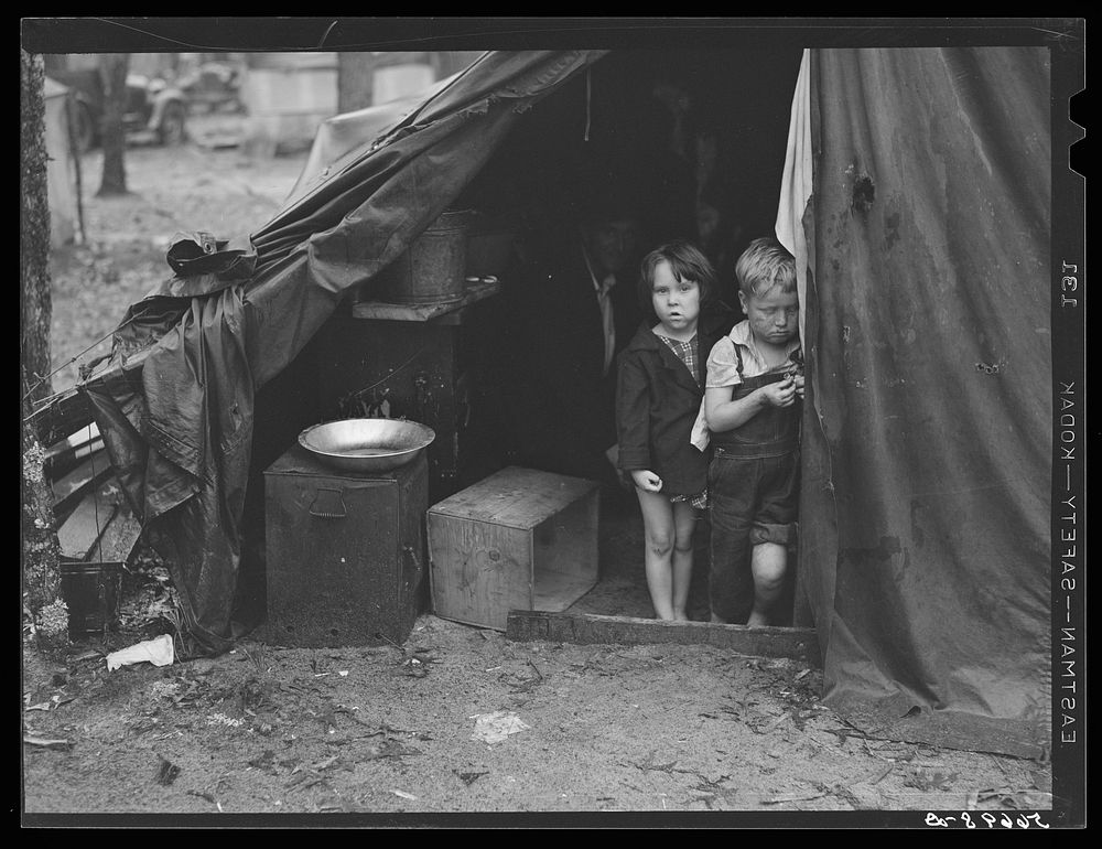 Children in tent home of construction workers. Ten men, two women and two children live here. Near Alexandria, Louisiana.…