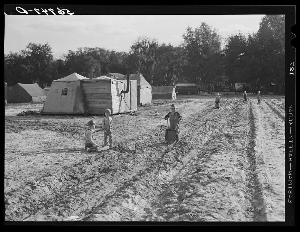 Construction workers' children playing in front of their shacks and tents in camp near Camp Blanding. Starke, Florida.…