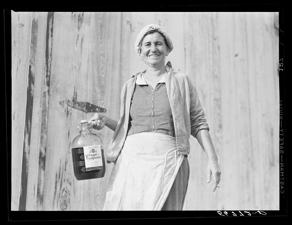 Spanish muskrat trapper's wife with gallon of red wine which is drunk in great quantities. Delacroix Island, Saint Bernard…