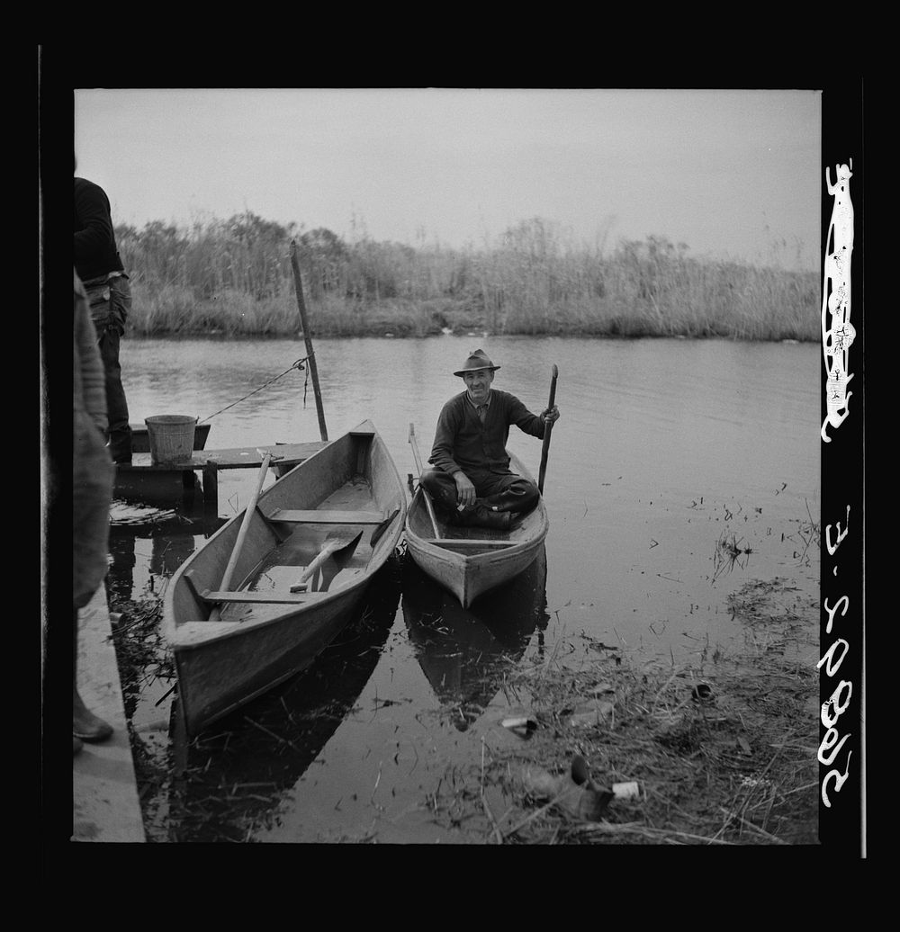 [Untitled photo, possibly related to: Spanish trapper returning home to his camp in the marshlands near Delacroix Island…