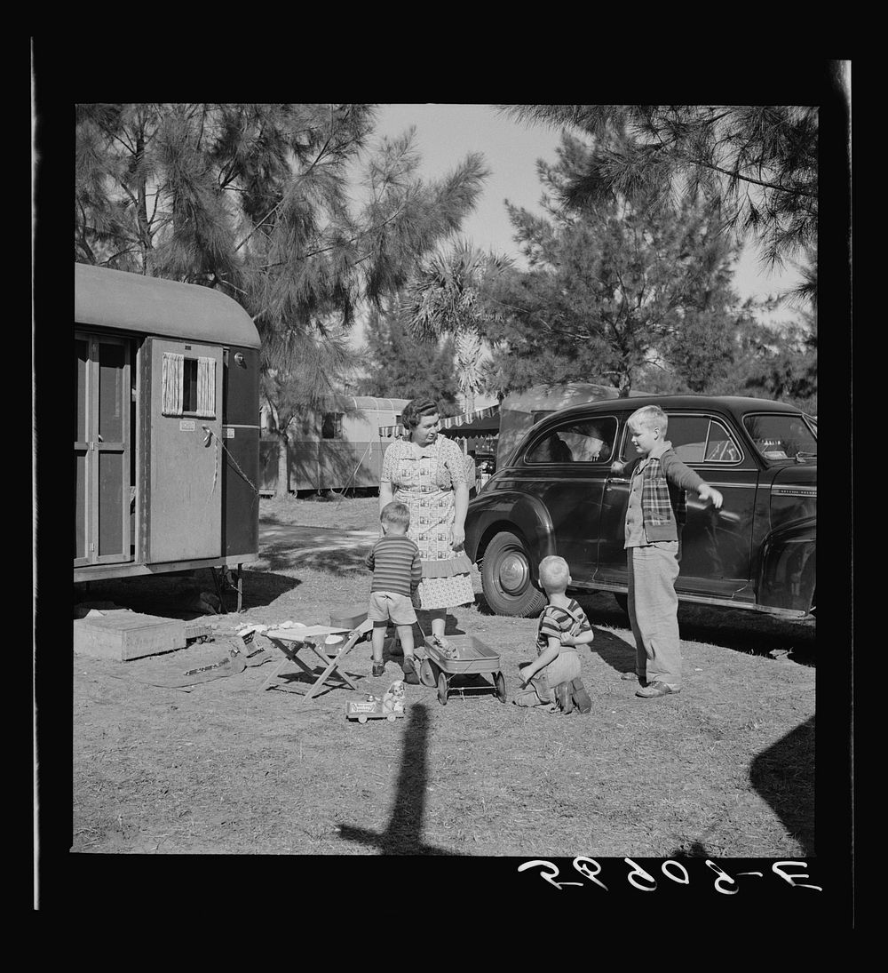 Children and their mother outside their trailer home. Sarasota trailer park, Sarasota, Florida. Sourced from the Library of…