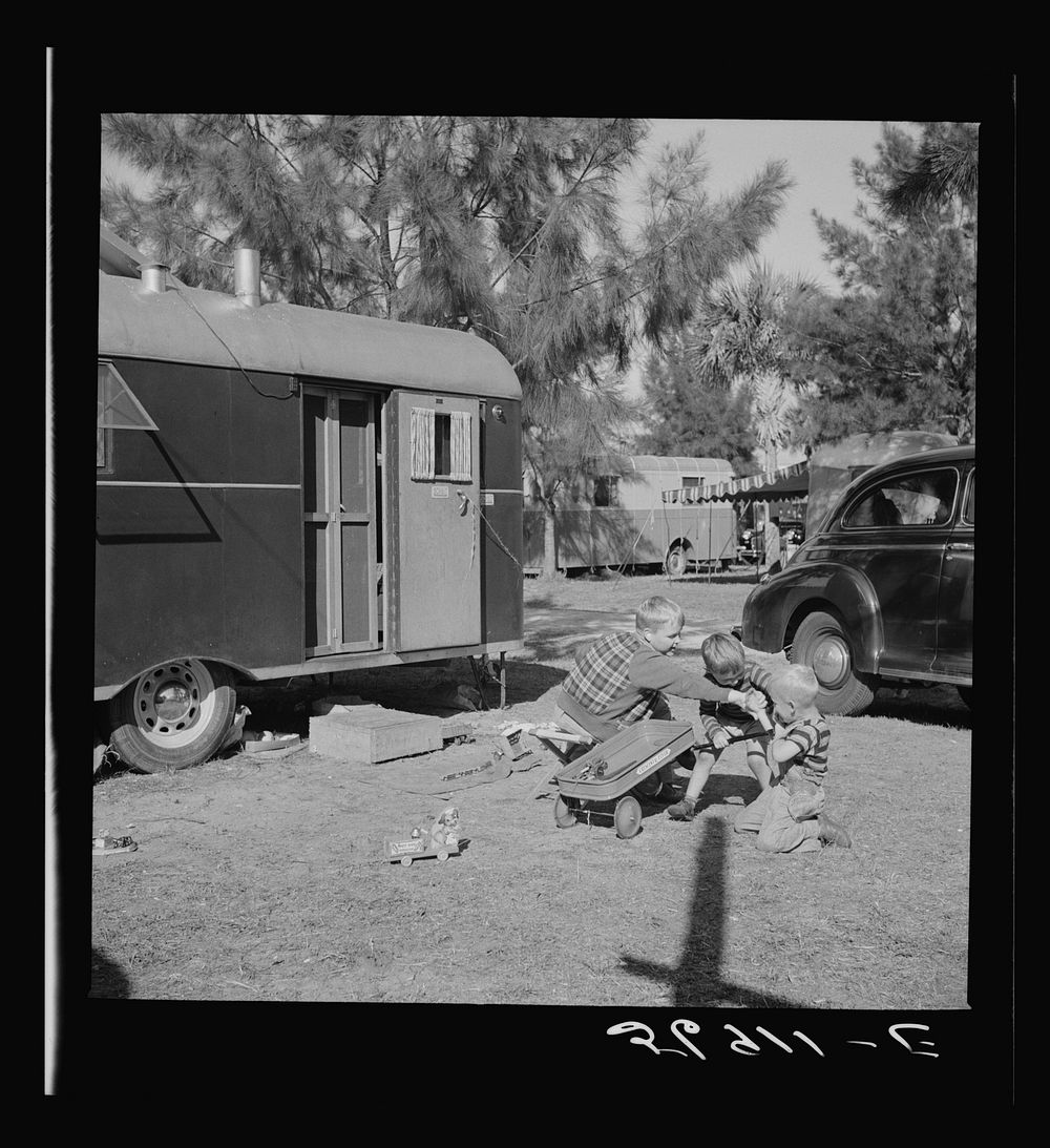 [Untitled photo, possibly related to: Children and their mother outside their trailer home. Sarasota trailer park, Sarasota…
