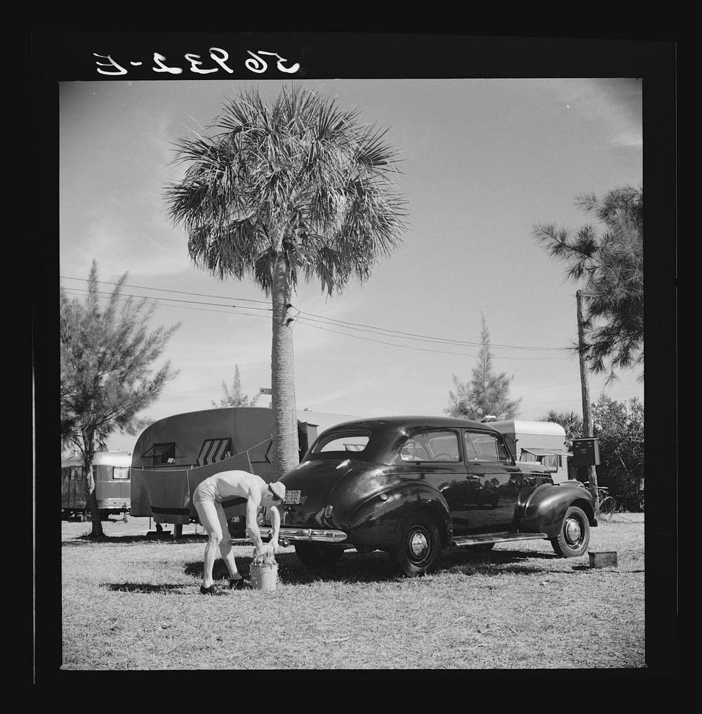 Guest at Sarasota trailer park, Sarasota, Florida, washing his car. Sourced from the Library of Congress.
