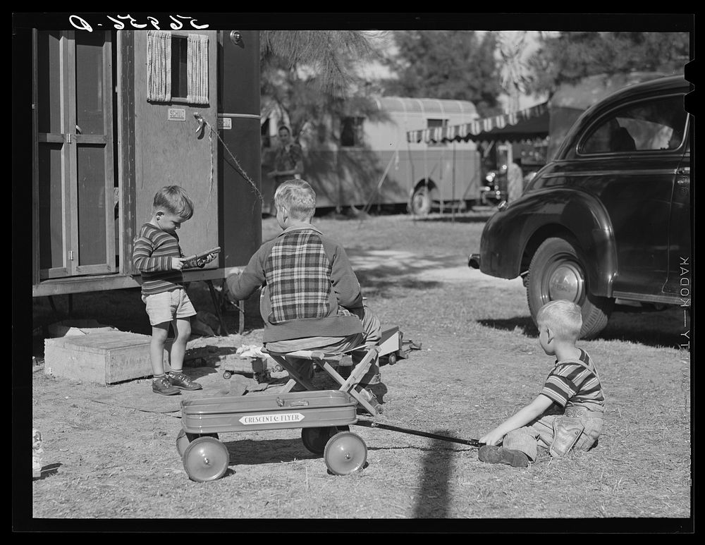 Children playing outside their trailer homes at Sarasota trailer park. Sarasota, Florida. Sourced from the Library of…