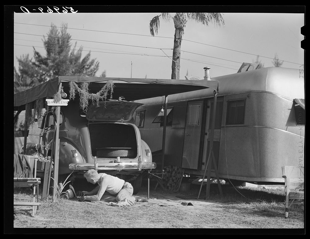 One of the guests at Sarasota trailer park, Sarasota, Florida, washing his car. He has named his trailer home "Loveless".…