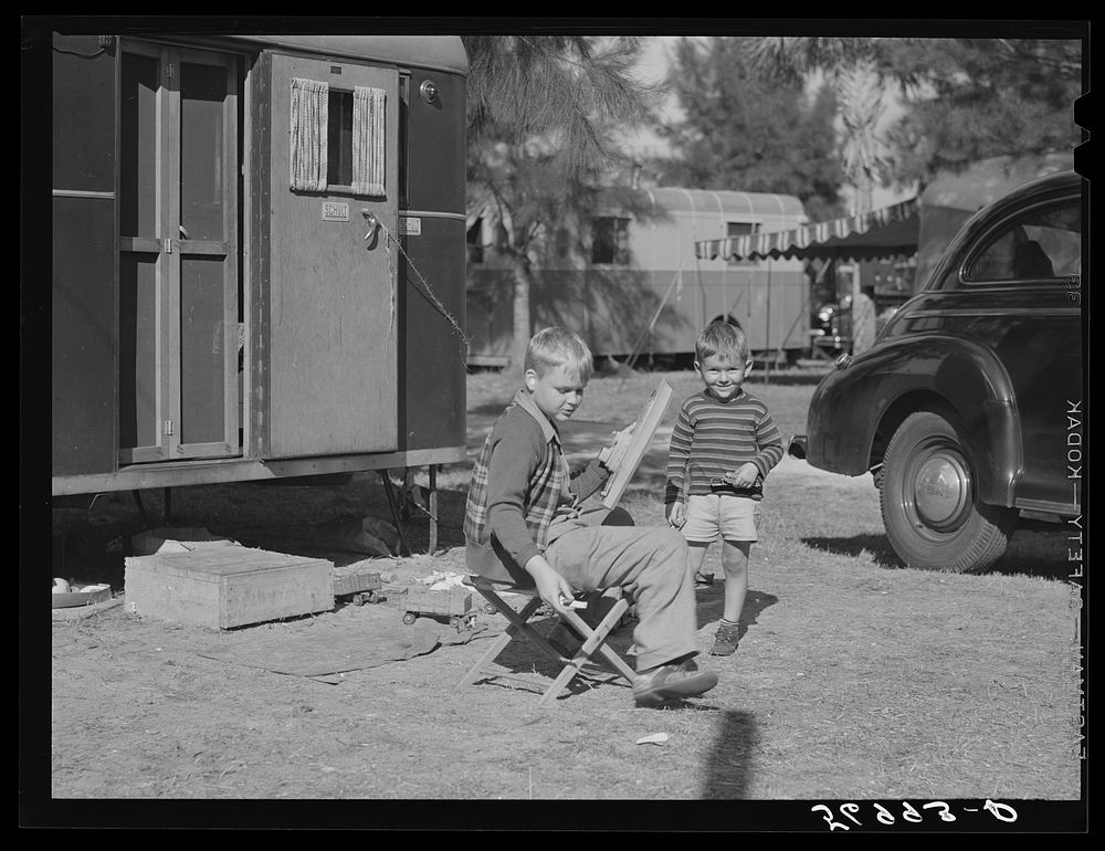 [Untitled photo, possibly related to: Children playing outside their trailer homes at Sarasota trailer park. Sarasota…