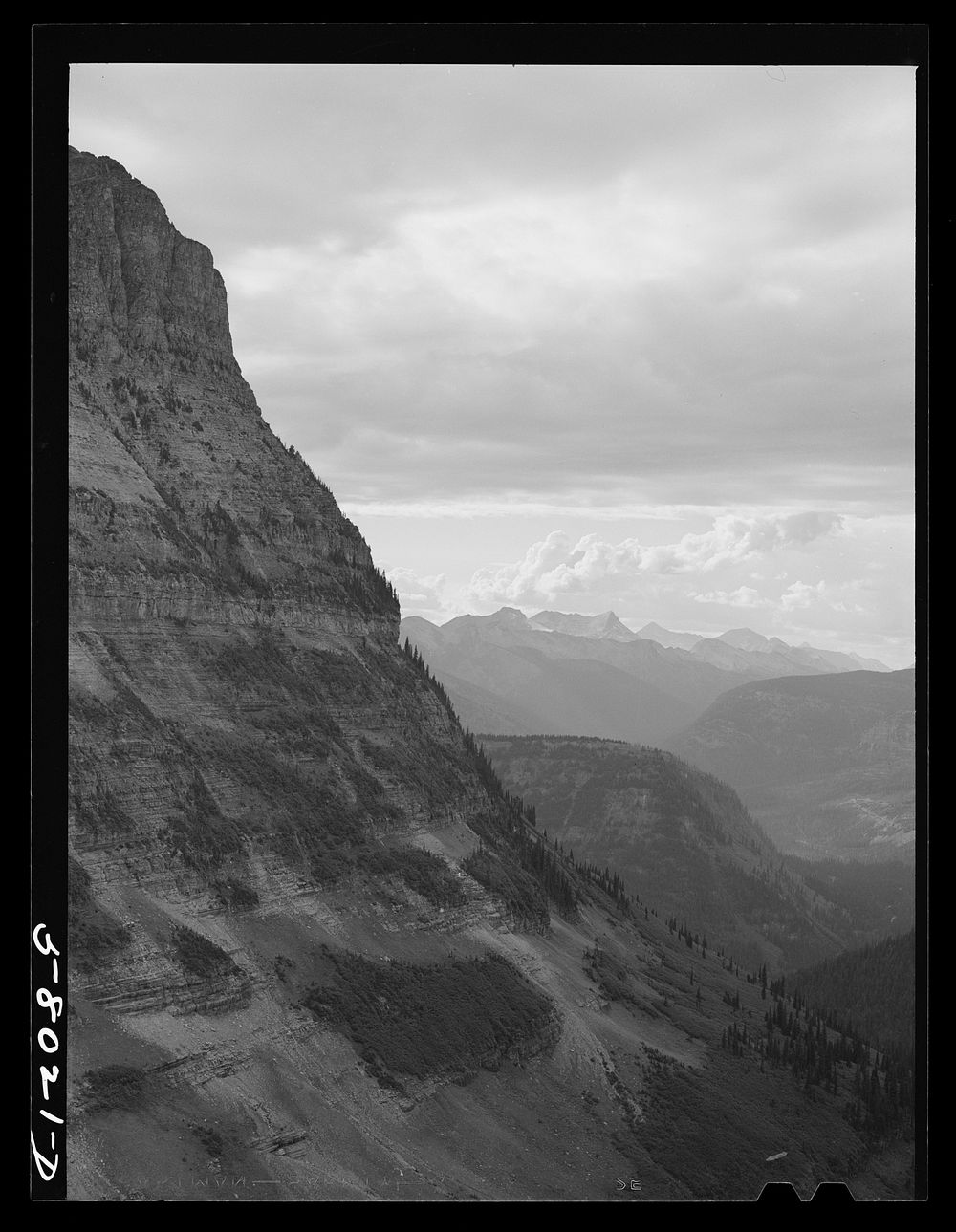 General view of Rocky Mountains west of Continental Divide seen from top of Logan Pass on Going-to-the-Sun highway. Glacier…