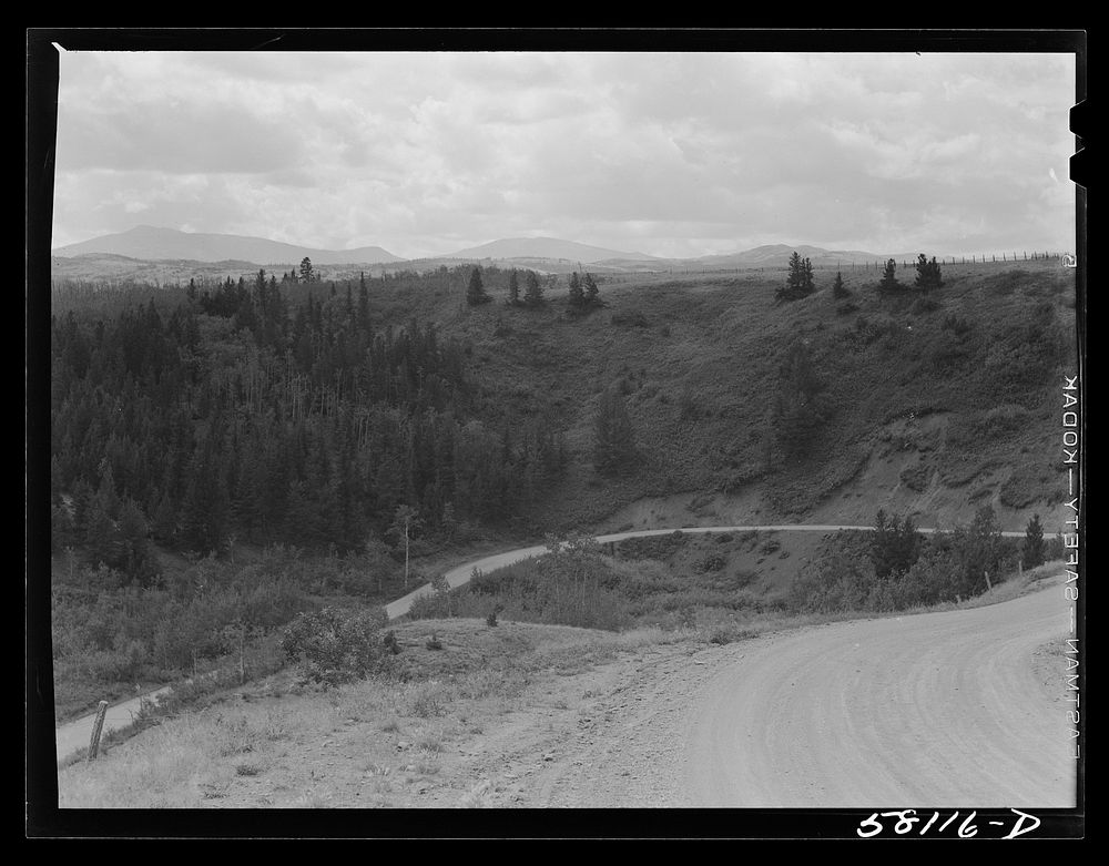 [Untitled photo, possibly related to: Winding approach to Glacier Park station. Glacier National Park, Montana]. Sourced…