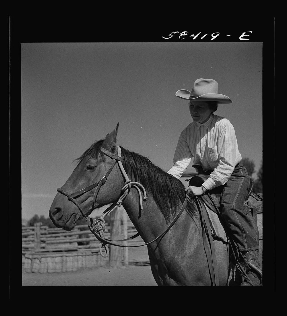 Mrs. Lyman Brewster on a ranch horse. In the corral at Quarter Circle U Ranch. Birney, Montana. Sourced from the Library of…