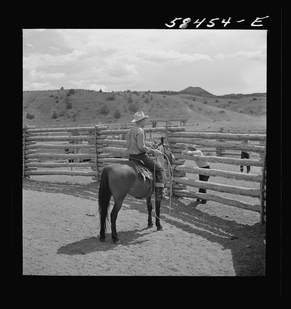 Dude on one of the ranch horses in the corral at Quarter Circle U, Brewster-Arnold Ranch Company. Birney, Montana. Sourced…