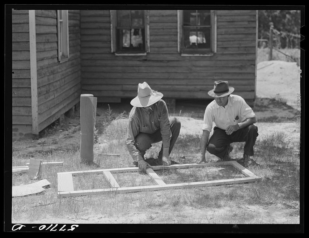 Fastening the stock with corrugated staples. Screen door construction. Charles County, La Plata, Maryland. Sourced from the…