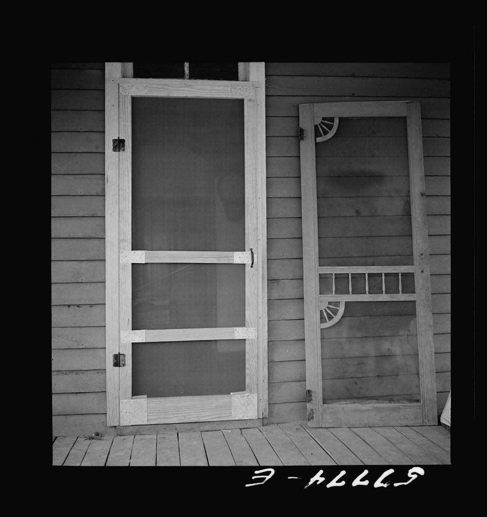 [Untitled photo, possibly related to: Door assembled in place alongside old door. Screen door construction demonstration.…