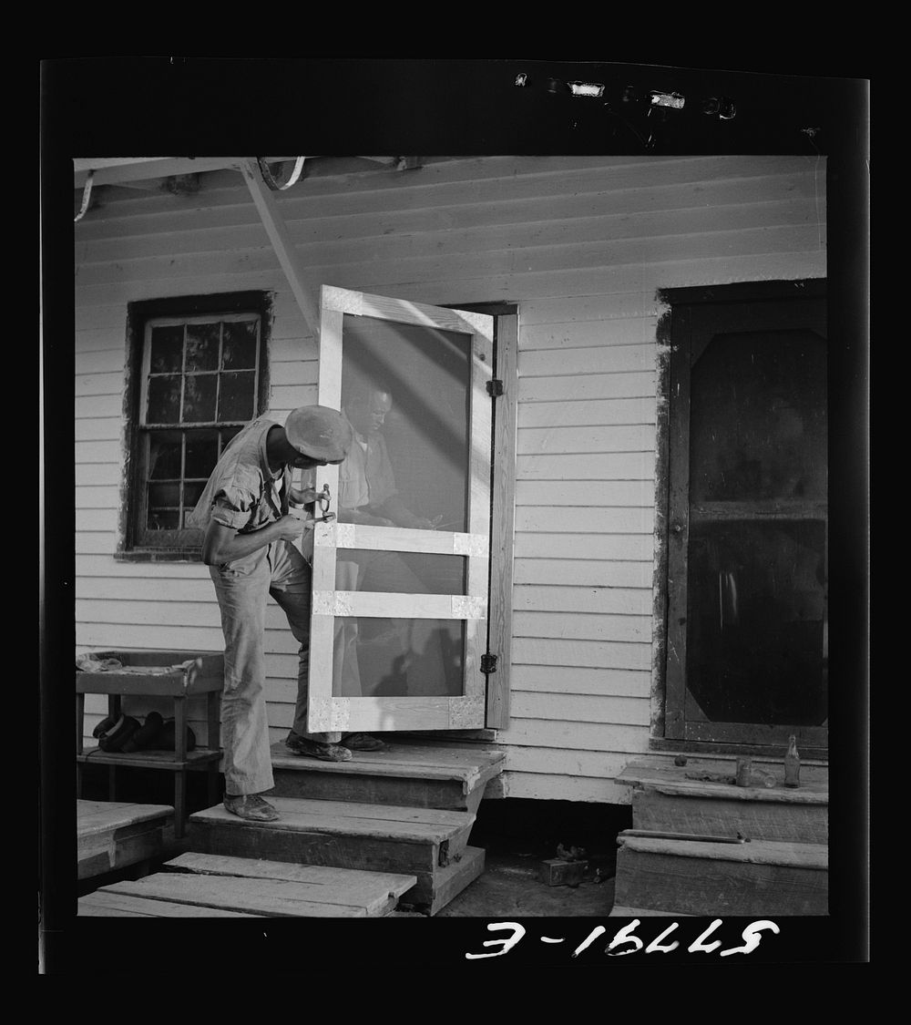 Handle, catch, and spring are added. Demonstration of home screen door construction. Saint Mary's County, Ridge, Maryland.…