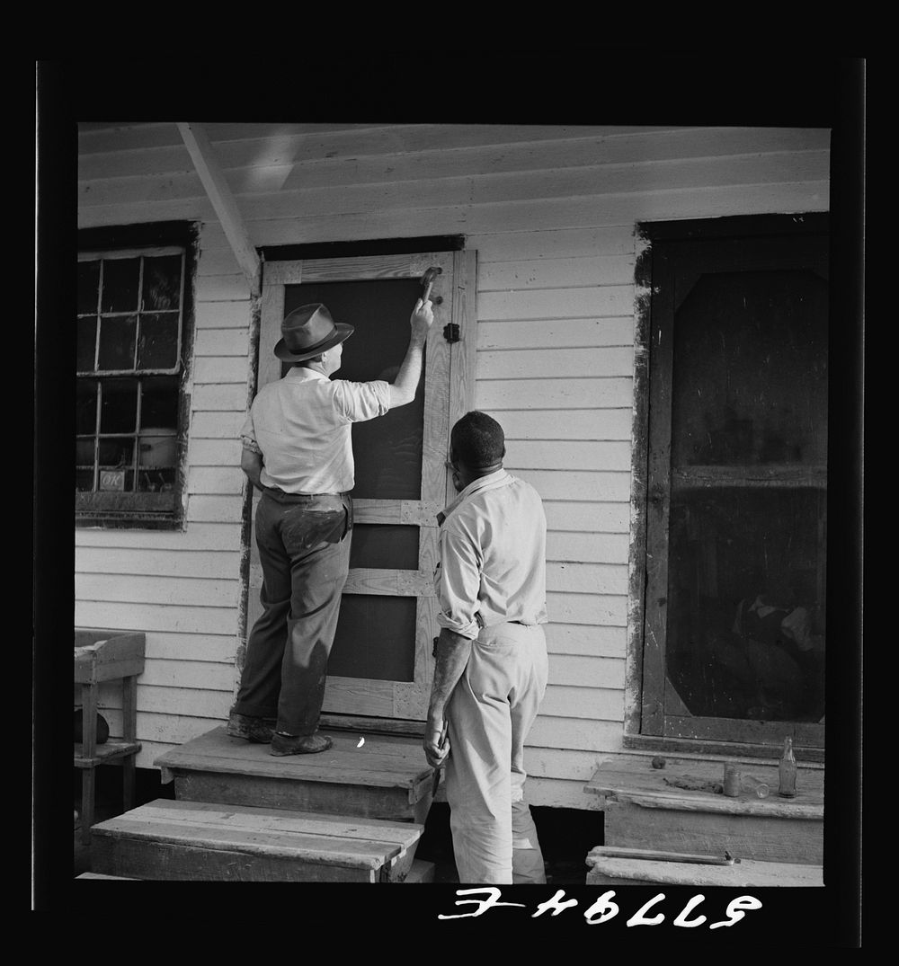 Nailing the hinge strip to the door frame. Saint Mary's County, Ridge, Maryland. Screening demonstration. Sourced from the…
