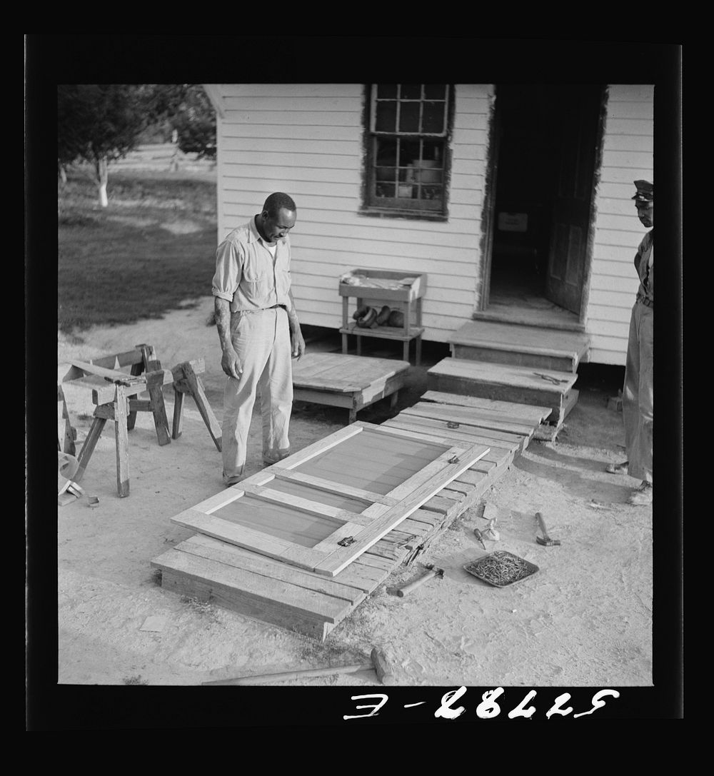 Door ready to be placed. Demonstration of home screen door construction. Saint Mary's County, Ridge, Maryland. Sourced from…