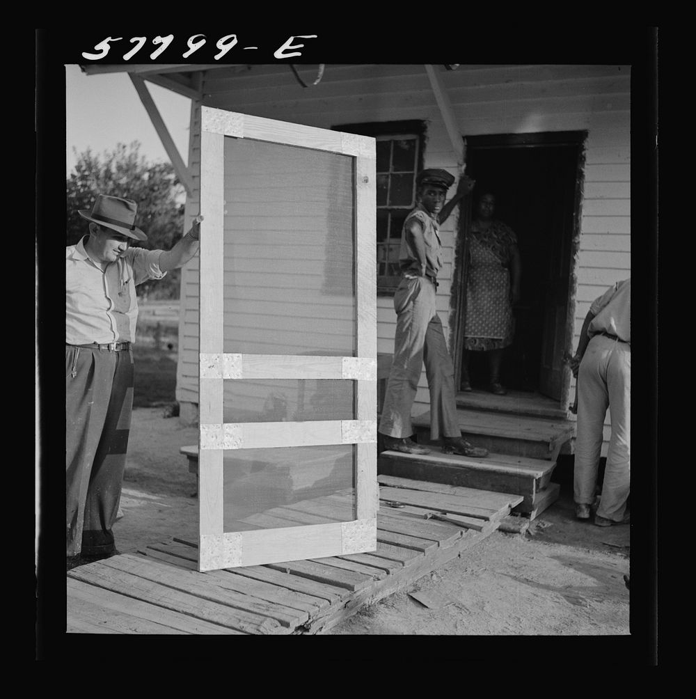 Door ready to attach to hinge strip. Demonstration of home screen door construction. Saint Mary's County, Ridge, Maryland.…