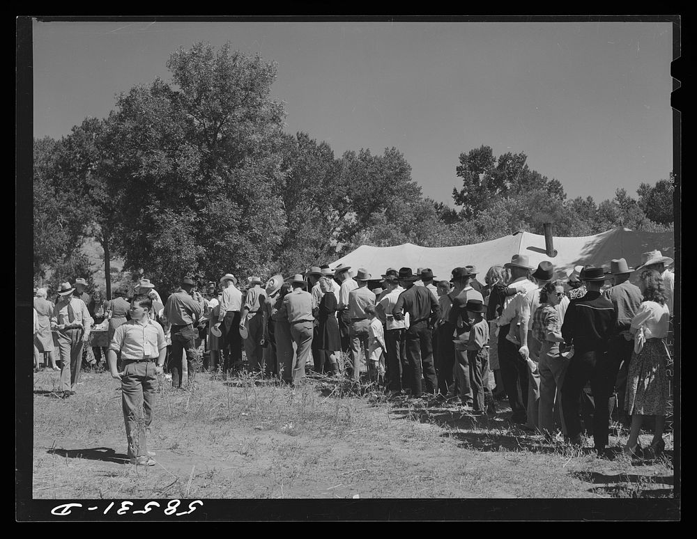 Line of guests waiting to get some barbecued beef at stockmens picnic. Spears Siding, Wyola, Wyoming. Sourced from the…
