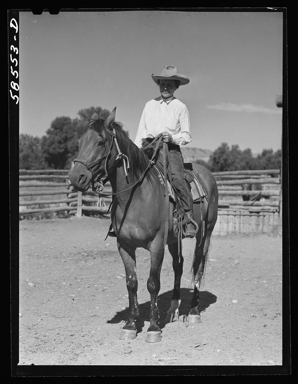 Mrs. Lyman Brewster on one of their ranch horses in the corral. Quarter Circle U, Brewster-Arnold Ranch Company. Birney…