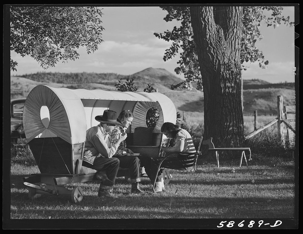 Quarter Circle U, Brewster-Arnold Ranch. Birney, Montana. Dudes in a covered wagon garden seat.. Sourced from the Library of…